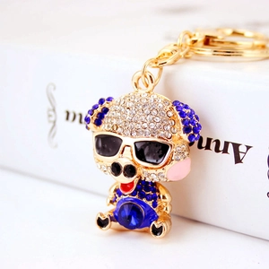 Cute golden pig keychain with sparkling blue rhinestones and sunglasses pendant