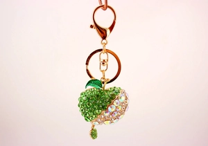 Detailed view of apple keychain with green rhinestones and sparkling crystal elements