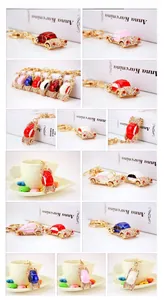 Close-up of colorful car-shaped keychains with rhinestones and gold-plated finish