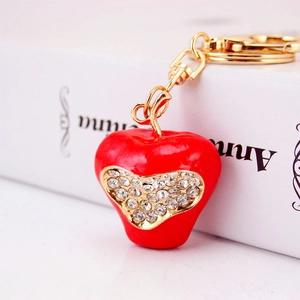 Red apple keychain with heart-shaped rhinestones and golden hardware for bags