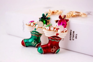 Close-up of rhinestone snow boot keychains with enamel details and golden DG logo charms