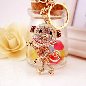 Sparkling rhinestone monkey keychain in gold-tone metal with crystals and enamel finish