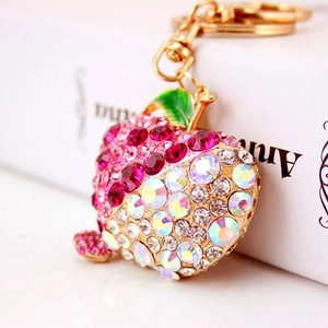 Sparkling rhinestone apple keychain with pink crystals and green leaf on golden metal base