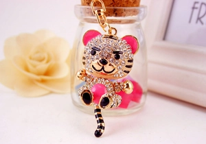 Macro detail of cartoon tiger keychain with gold plating and sparkling rhinestones