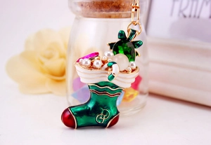 Detail of Christmas stocking keychain featuring colorful rhinestones and green enamel