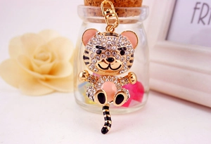 Close-up of golden cartoon tiger keychain with sparkling rhinestones and enamel details