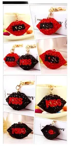 Detail view of sparkling rhinestone kiss lip keychains in red and black color options