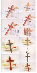 Macro detail of rhinestone cross keychain in multiple colors with gold plating