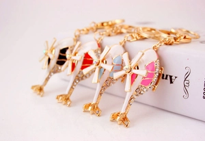Detail of four colorful helicopter keychains with gold plating and sparkling rhinestones