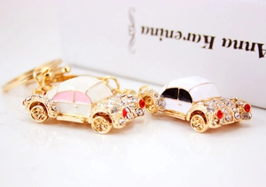 Close-up of vintage car keychains with gold plating and sparkling crystals