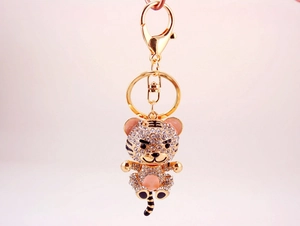 Detail of a sparkling gold-plated tiger keychain with rhinestones and enamel accents