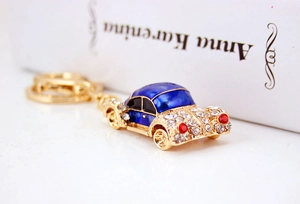Macro shot of vintage car keychain featuring blue enamel and sparkling rhinestones