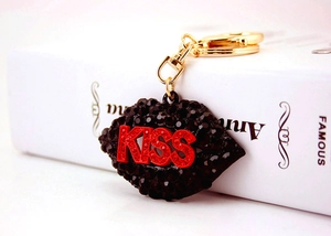 Detail of red KISS letter rhinestones on black crystal lip shaped keychain charm