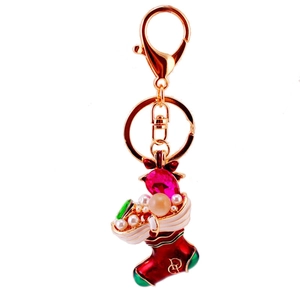 Christmas stocking keychain with red green enamel and rhinestones on white background
