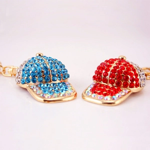 Sparkling rhinestone baseball cap keychains in blue and red with gold alloy finish