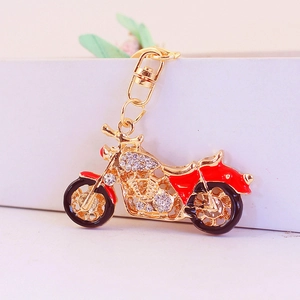 Golden motorcycle keychain with red enamel and sparkling rhinestones on a metal clip