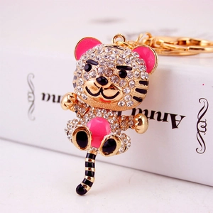 Sparkling tiger zodiac keychain with crystals and pink enamel on a gold metal base
