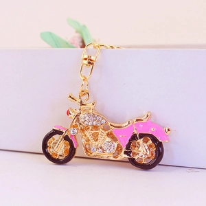 Golden rhinestone motorcycle keychain with pink enamel details and lobster clasp
