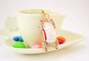 Close-up of a beetle car keychain with sparkling rhinestones and white enamel details