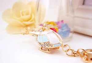 Detailed close-up of helicopter keychain with gold alloy finish and sparkling rhinestones
