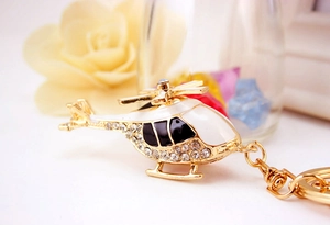 Detailed close-up of helicopter keychain featuring gold plating and sparkling rhinestones