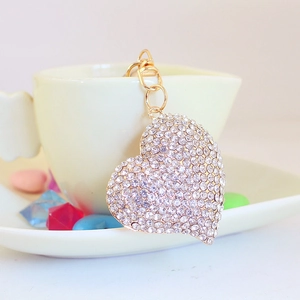 Sparkling rhinestone heart keychain for women bags with golden chain on white cup