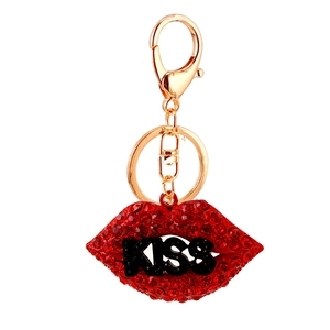 Sparkling red rhinestone lip keychain with black KISS lettering on a gold-tone lobster clasp