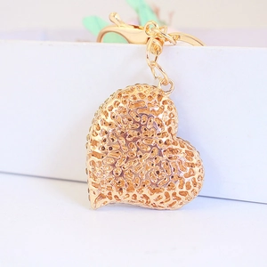 Golden heart-shaped rhinestone keychain with intricate hollow design for handbags