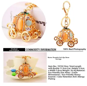 Close-up of pumpkin carriage keychain with orange cat eye stones and white rhinestones