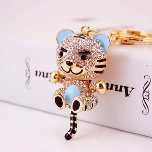 Cute cartoon tiger keychain with sparkling white crystals and blue enamel accents