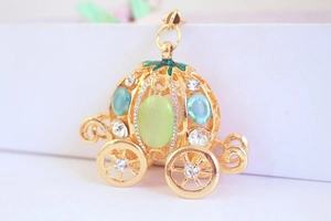 Macro detail of pumpkin carriage pendant with sparkling rhinestones and blue gemstones