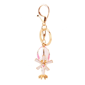 Golden helicopter keychain with pink enamel and rhinestones on a white background