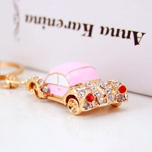 Creative pink enamel car keychain with white rhinestones on a gold-plated metal base