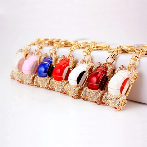 Creative car keychain set with gold alloy frames, colorful enamel finish, and sparkling rhinestones