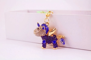 Detailed view of unicorn keychain featuring deep blue rhinestones and gold plating