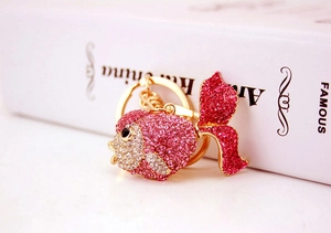 Close-up of goldfish keychain with pink and white rhinestones on gold alloy base