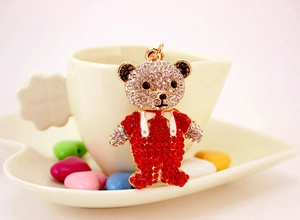 Gros plan du porte-clés ourson mignon serti de strass rouges et blancs sur une tasse