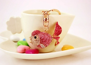 Close-up of pink and white crystal goldfish keychain with gold-plated lobster clasp