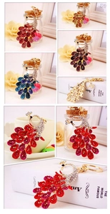 Detailed close-up of colorful rhinestone peacock keychain with vibrant crystal accents