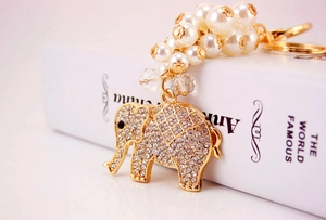 Detailed close-up of elephant keychain featuring inlaid rhinestones and elegant white pearls