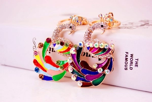 Detailed close-up of colorful peacock keychains with enamel and rhinestone embellishments