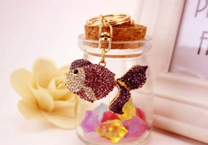 Detailed view of goldfish keychain with purple crystals and golden lobster clasp