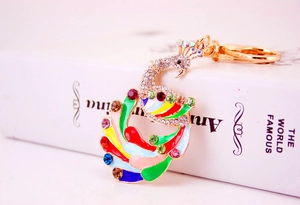Macro detail of a colorful peacock keychain with multi-color oil drip and crystal rhinestones
