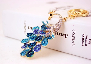 Close-up of blue crystal peacock keychain with detailed gradient rhinestone inlay
