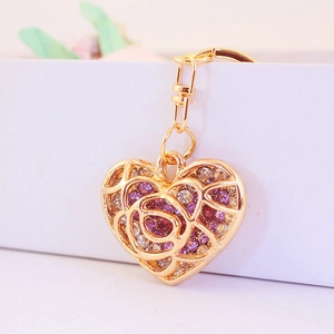 Creative hollow heart keychain with purple rhinestones and golden floral engraving