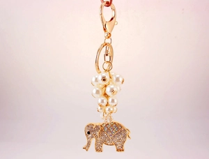 Detailed macro shot of elephant keychain with sparkling rhinestones and white pearls