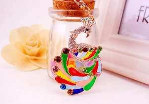 Detailed close-up of colorful enamel peacock keychain with sparkling crystal accents
