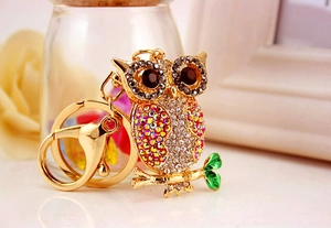 Close-up of colorful crystal owl keychain with gold plating and sparkling AB rhinestones