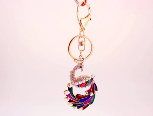 Macro shot of colorful enamel peacock keychain with sparkling rhinestones and lobster clasp