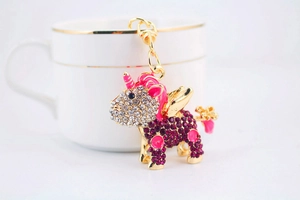 Detailed view of sparkling pink rhinestone unicorn keychain with gold metal plating